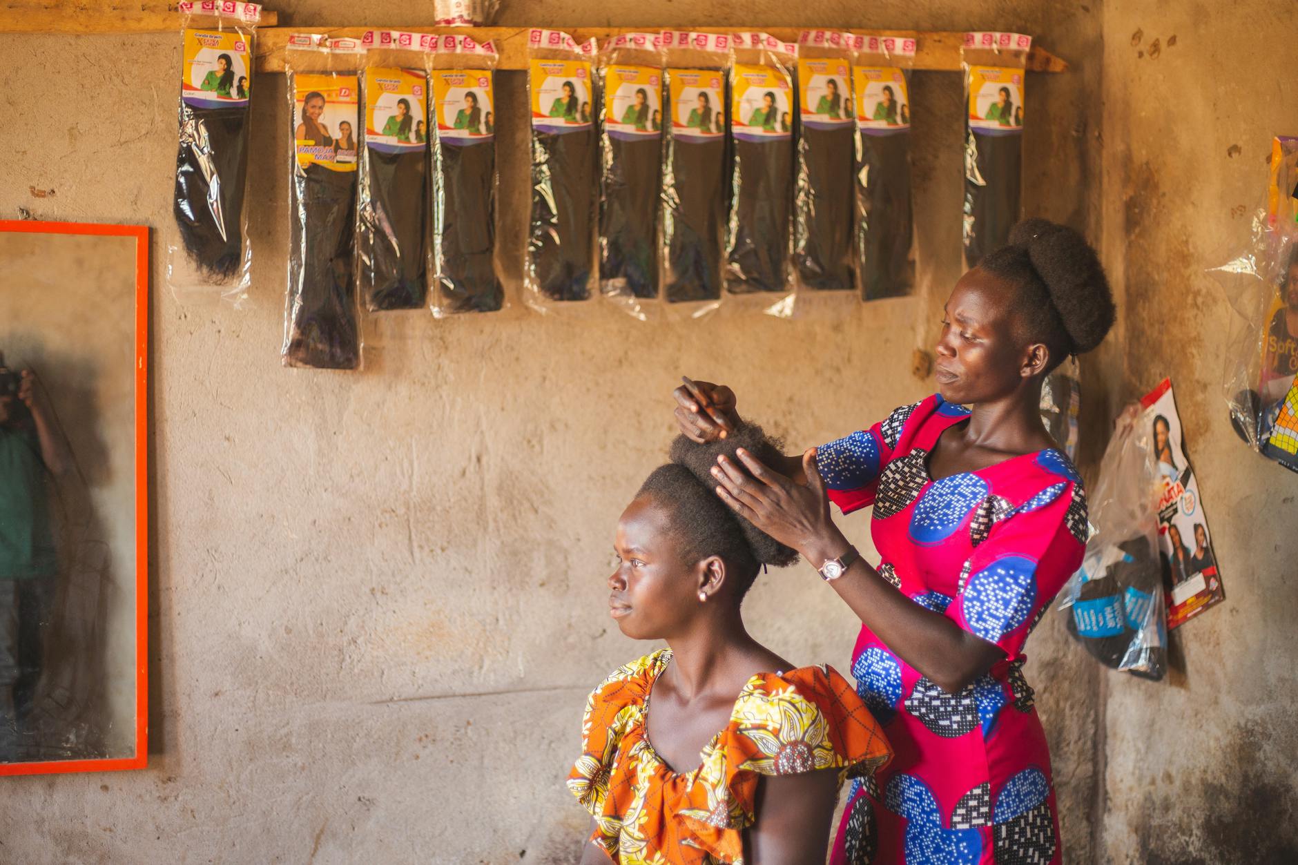 hairdresser in africa making a hair extension